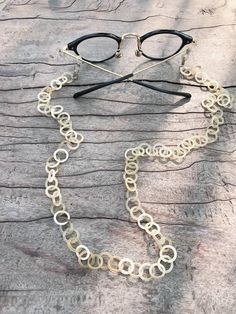 Buffalo horn eyeglass chain , Horn eyewear chain , Blonde horn eyeglasses holder , Eyesglasses Accessories, Eyeglasses NecklaceThis Modern Retro Buffalo Horn Eyeglasses, Reading Glass and Sunglasses Chain will added a touch of shimmer and sophistication to your style. This buffalo horn glasses chain has beautiful shiny links in shades of natural blonde horn . This upscale eyeglass chain also has stainless steel clasps so you that you could easily switch the grips of needed. SIZE:Length: 41 cm (1 Elegant Metal Glasses Chains As Fashion Accessory, Metal Glasses Chains As Gift, Elegant Glasses Chains With Chain Strap As Gift, Adjustable Gold Glass Chain For Glasses, Elegant Handmade Metal Glasses Chains, Metal Glasses Chain With Adjustable Chain As Gift, Modern Metal Glasses Chains With Adjustable Chain, Trendy Handmade Gold Glasses Chain, Elegant Glass Necklace With Chain Strap