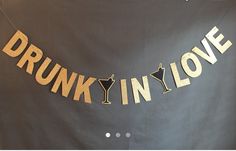 a sign that says drunk in love hanging from a string