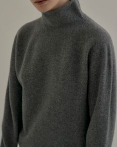 Relaxed, soft 100% wool mock turtleneck. Slouchy, and perfect alone or under blazers and coats. - Rolled mock turtleneck- Ribbed hem, and cuffs - Length 25", Bust 42", Sleeve 31"- 100% wool- Dry clean - Imported High Neck Wool Sweater For Work, Classic Solid Funnel Neck Turtleneck, Solid Cashmere Turtleneck For Workwear, Classic Winter Outerwear With Funnel Neck, Classic Gray Sweater For Workwear, Classic Funnel Neck Winter Outerwear, Workwear Turtleneck With Funnel Neck, Classic High Neck Turtleneck, Wool Turtleneck Outerwear