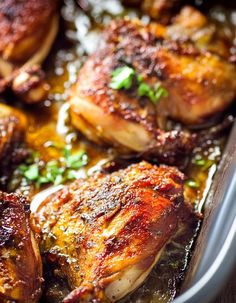 some chicken is cooking in a pan on the table