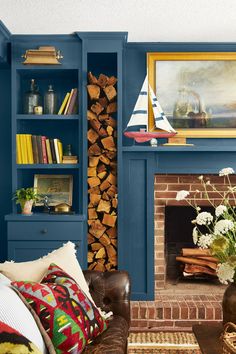 a living room filled with furniture and a fire place next to a painting on the wall