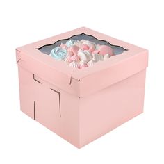 a pink box filled with lots of different types of flowers on top of each other