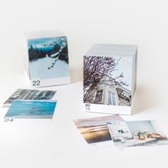 several polaroid photos are placed next to each other on a white surface, including one with a house and trees