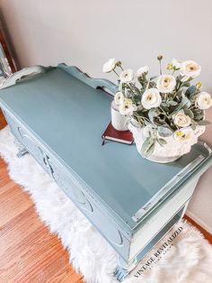 a blue table with flowers on top