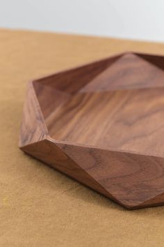 a wooden bowl sitting on top of a table