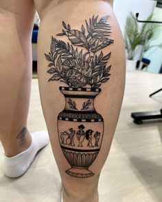 a woman's legs with a vase and flowers on it