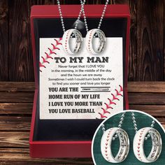 two baseball necklaces in a red box with an i love you to the moon and back message