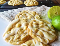 cookies with icing and limes on a white plate