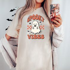 This retro Spooky Season Halloween Comfort Colors Tee is perfect for the upcoming Halloween season. This shirt puts a trendy twist on the spooky season.  Spooky Vibes Retro Halloween Shirt, Women's Comfort Colors Tee, Oversized Cozy T-Shirt, Women's Halloween T-Shirt, Neutral Halloween Shirt T-Shirt Description Comfort Colors is back with its garment-dyed t-shirt, a fully customizable tee made 100% with ring-spun cotton. The soft-washed, garment-dyed fabric brings extra coziness to your wardrobe Oversized White T-shirt For Halloween, Neutral Halloween, Spooky Vibes, Comfort Colors Tee, Retro Halloween, Halloween T Shirt, Halloween Women, Halloween Season, Dyed Fabric