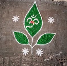 a green leaf painted on the side of a wall