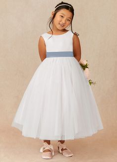 Kavi is our adorable flower girl dress cut from satin and tulle. She features a scoop neckline paired, the look is complete with an A-line skirt. White Tulle Bridesmaid Dress For Pageant, White Tulle Bridesmaid Dress For First Communion, Sleeveless Tulle Dress For First Communion, Sleeveless Tulle Skirt Dress For First Communion, White Sleeveless First Communion Dress With Tulle Skirt, Sleeveless Tulle Skirt Dress For Confirmation, Spring Confirmation Princess Dress With Tulle Skirt, Tulle Princess Dress For Confirmation, Princess Style Tulle Bridesmaid Dress For First Communion