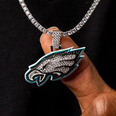 Nothing accentuates your fit like the perfect drip! GLD has teamed up with the National Football League to introduce the official NFL Team Pendants. This piece was meticulously crafted with a mixture of clear and black hand-set stones to accurately depict the logo of the Philadelphia Eagles. Boss up and rep your squad with the official pendant of the Philadelphia! This product is guaranteed for life - GLD will repair the item should you experience any defects in craftsmanship or breakage. Pendan Luxury Diamond Jewelry For Streetwear, Luxury Bling Jewelry For Streetwear, Black Pendant Jewelry For Streetwear, Luxury Black Iced Out Jewelry, Luxury Iced Out Black Jewelry, Luxury Black Bling Jewelry, The Eagles, Gold Piece, Vermeil Jewelry