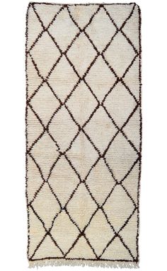 a white rug with brown and black squares on the bottom, in front of a white background