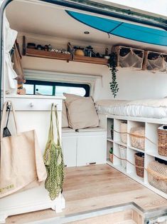 the inside of a camper with shelves, baskets and storage space on each side