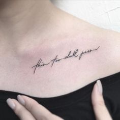 a woman's chest with the words, this too shall you written in cursive font