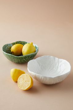 two bowls with lemons in them on a table