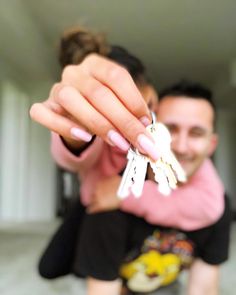 a man and woman holding keys in their hands