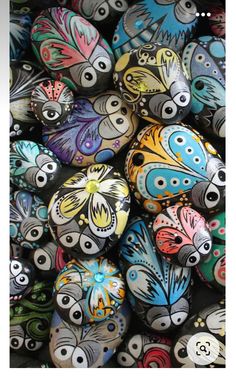 many different colored rocks with eyes painted on them