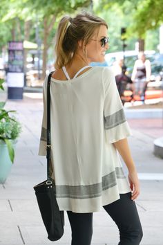 This tunic is sporty chic at its finest! It has a long length and swing fit - perfect for wearing with active pants or leggings!  Fabric is a soft and stretchy rayon-blend. Stretch Athleisure Activewear For Day Out, Chic Spring Yoga Activewear, Casual Stretch Tunic For Spring, Casual Stretch Activewear For Day Out, White Casual Tunic For Loungewear, Blue Door, Sporty Chic, Long Length, Boutique Clothing