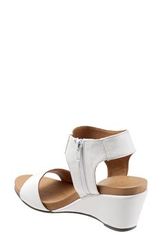 A wide, halter cuff enhances the contemporary appeal of this sleek wedge sandal. 2 3/4" heel Side zip closure Leather upper and lining/synthetic sole Imported Women's Shoes Open Toe Wedge Sandals With Arch Support, Leather Low Heel Wedge Sandals With Arch Support, Open Toe Wedge Sandals With Stacked Heel, Low Heel Leather Wedge Sandals With Arch Support, Leather Wedge Sandals With Arch Support And Low Heel, Wedge Sandals With Stacked Heel And Open Toe, Medium Width Open Toe Wedge Sandals With Stacked Heel, Modern Open Toe Wedge Sandals With Removable Insole, Leather Open Toe Sandals With Zipper