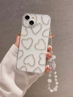 a person holding up a cell phone case with beads on the front and back cover