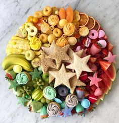 a plate filled with lots of different types of food on top of a marble table