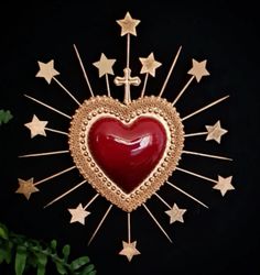 a red heart surrounded by gold stars on a black background