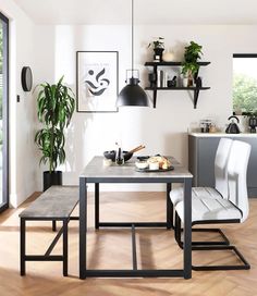 a dining room table with two chairs next to it