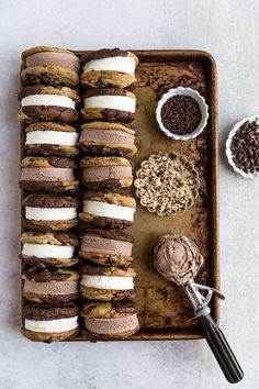 an overhead view of chocolate cookies and marshmallows on a baking tray with other ingredients