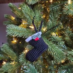 a crocheted stocking hanging from a christmas tree