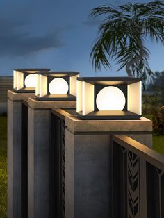 three outdoor lights on top of cement pillars