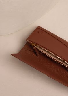 The "Sierra Wallet" incorporates two design features that are central to Polène's aesthetic: rounded shapes and leatherwork in contrasting colors and trim. Chic Brown Coin Purse With Card Slots, Elegant Brown Coin Purse For Everyday, Luxury Leather Card Holder With Coin Pocket, Classic Brown Business Coin Purse, Chic Brown Card Holder With Card Slots, Chic Brown Card Holder For Everyday Use, Chic Brown Card Holder With Slots, Modern Brown Clutch For Daily Use, Modern Cognac Wallets With Card Slots