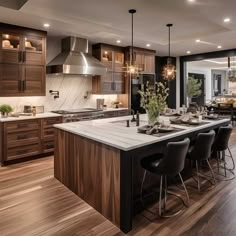 a large kitchen with an island in the middle and lots of counter space on one side