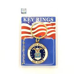 a key ring with an air force emblem on it's front and back sides