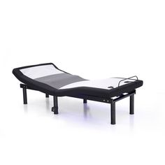 a black and white bed sitting on top of a metal frame