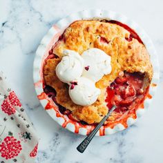 a strawberry cobbler with ice cream on top