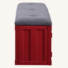 a red bench with a gray cushion on it