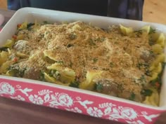 a casserole dish with broccoli and cheese in it on a table