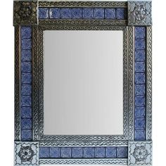 a blue and white mirror sitting on top of a counter next to a wall mounted faucet