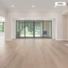 an empty living room with french doors and hard wood flooring on the side wall