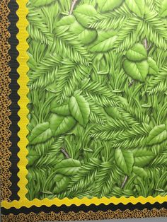 a painting of green leaves on a yellow and black background