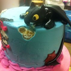 a birthday cake decorated with an image of a dragon