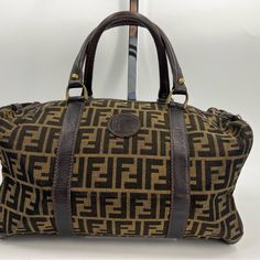 Fendi Zucca Vintage Duffle Bag Tan And Brown With Classic Fendi Print Approximately 13l X 8w X 7h Functional Zipper (With A Lock) Item Shows Signs Of Wear From Normal Use- Slight Discoloration Inside As Well As Outside Lining, Wear Of Stitching Inside, Ect. Please Refer To Photos For Further Details Sku: 2zantp82668 Fendi Print, Fendi Bags, Travel Bags, Duffle Bag, Fendi, Stitching, Bag Lady, Zipper, Signs