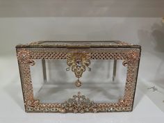 an elaborately designed mirror with gold trimmings and jeweled decorations on it