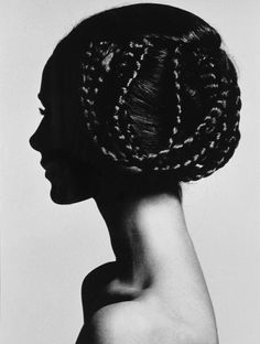 a black and white photo of a woman's head with braids in her hair