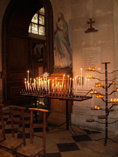 many candles are lit in front of the alter