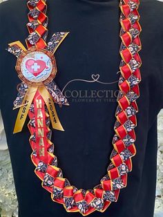 a woman wearing a black shirt with red and gold ribbon around her neck is shown