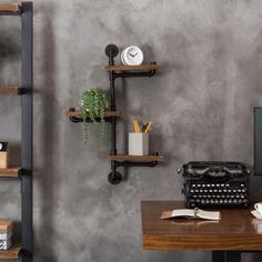 a desk with a typewriter, bookshelf and other items on the shelves