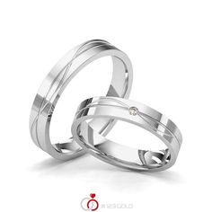 two white gold wedding rings with diamond in the center and an inscription i love you