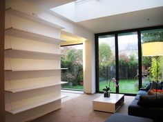 a living room filled with furniture next to a large glass door leading to a back yard